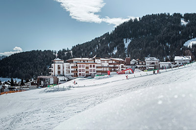ski-in ski-out at 5-star hotel Schlosshotel Fiss Tyrol Austria exterior view winter teaser